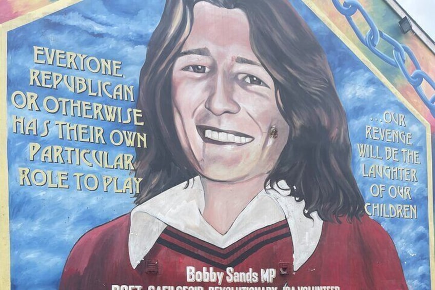 A mural with a person wearing a red and white outfit, and text including 'Everyone Republican or otherwise has their own particular role to play' and 'Our revenge will be the laughter of our children'. 2