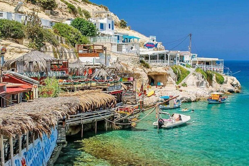A coastal village with traditional buildings, a pier, and boats. 5