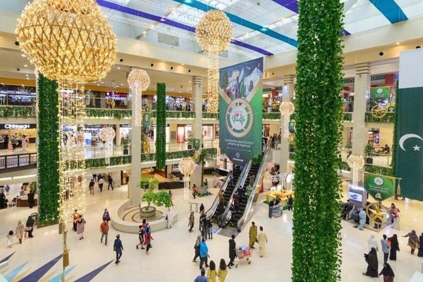 A shopping mall with multiple levels, escalators, and decorative spherical lights. 4