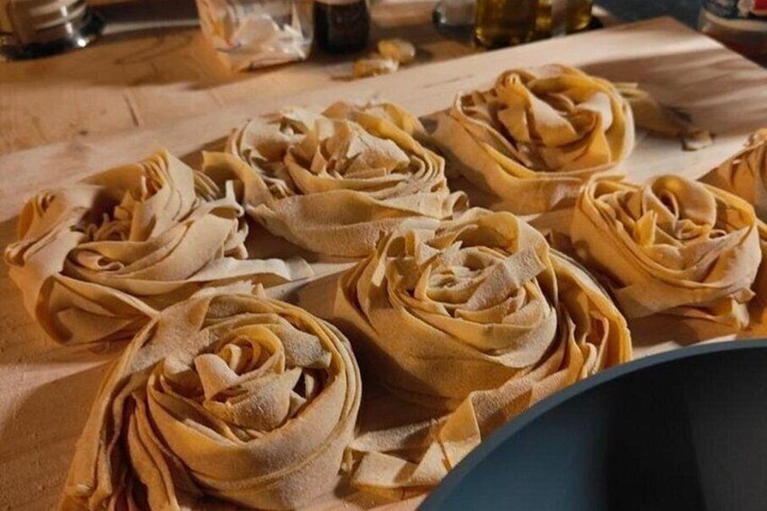 Pasta shaped like flowers on a wooden surface. 2