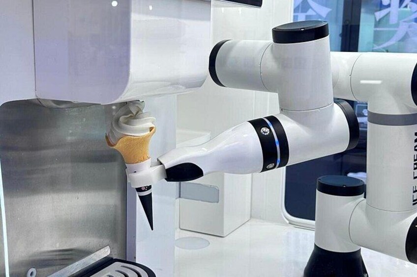 A robotic arm interacting with an ice cream cone. 3