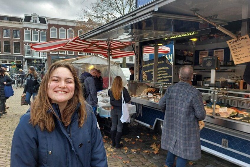 A street food market with a food stall and people shopping. 4