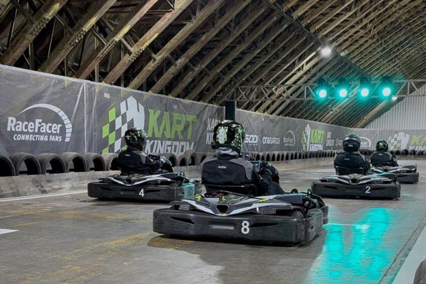Des karts sur une piste, avec des numéros de course et des banderoles. 4