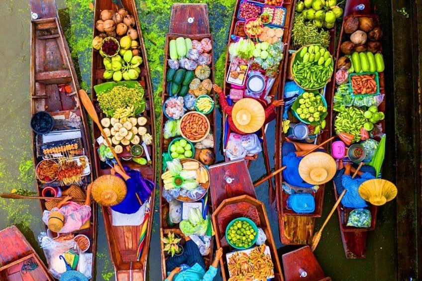 A group of canoes loaded with various fruits and vegetables. 1