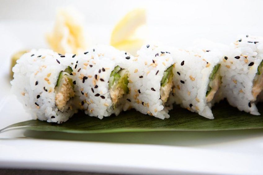 Sushi rolls with sesame seeds on a white plate. 5