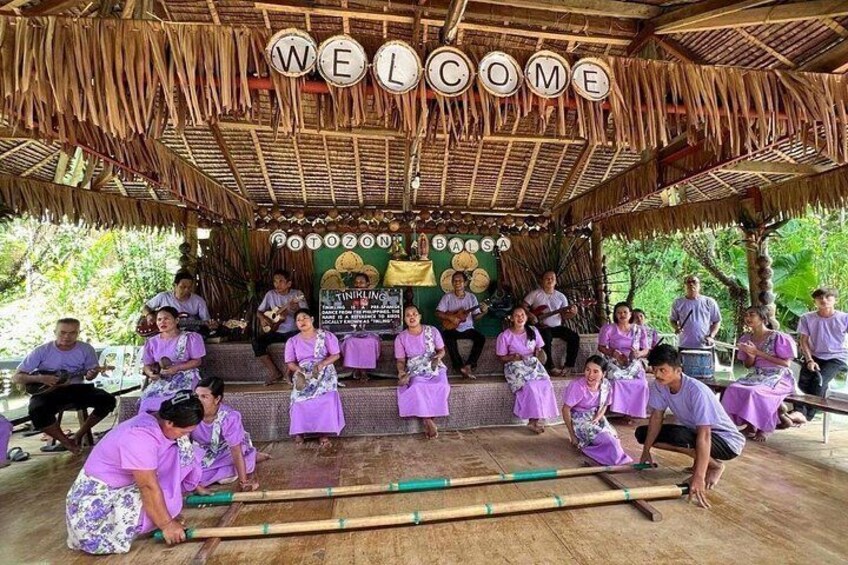 Performers in traditional Filipino attire entertain guests with a tinikling dance and local music during the Loboc River Cruise cultural show. 5