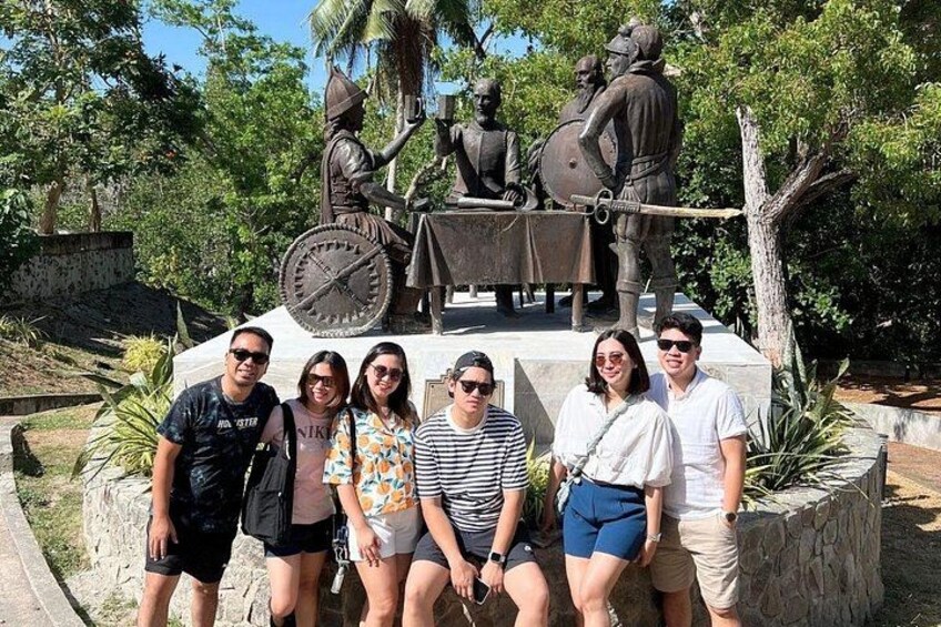 A group of friends poses in front of the historic Blood Compact Monument, a significant landmark commemorating the first international treaty of friendship. 4