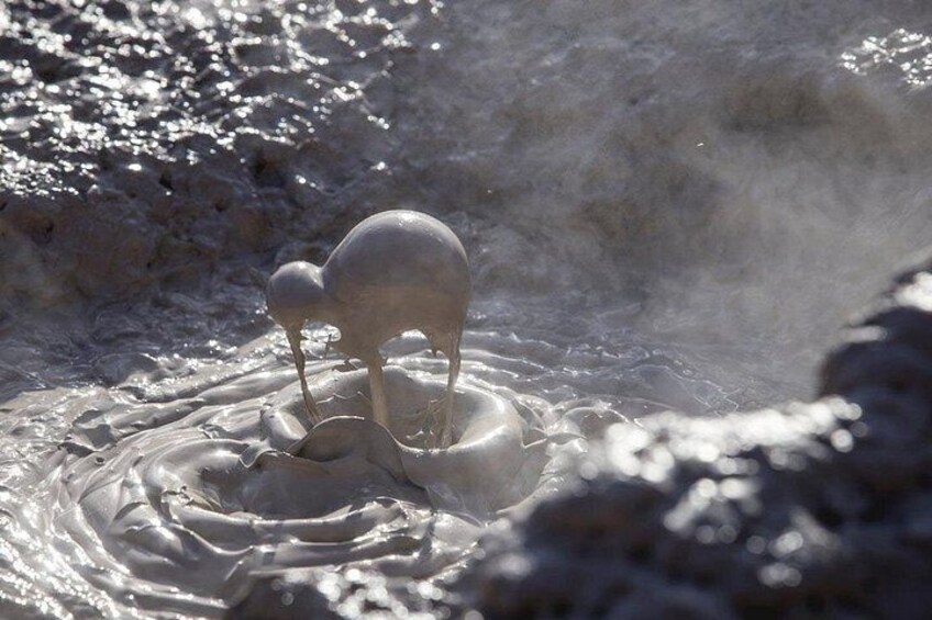 A geyser with water spouting upwards, surrounded by steam and mist. 1