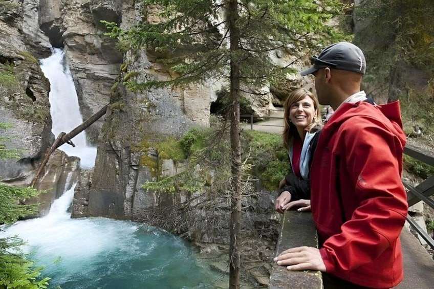 A waterfall, rocky terrain, and a person in a red jacket. 5
