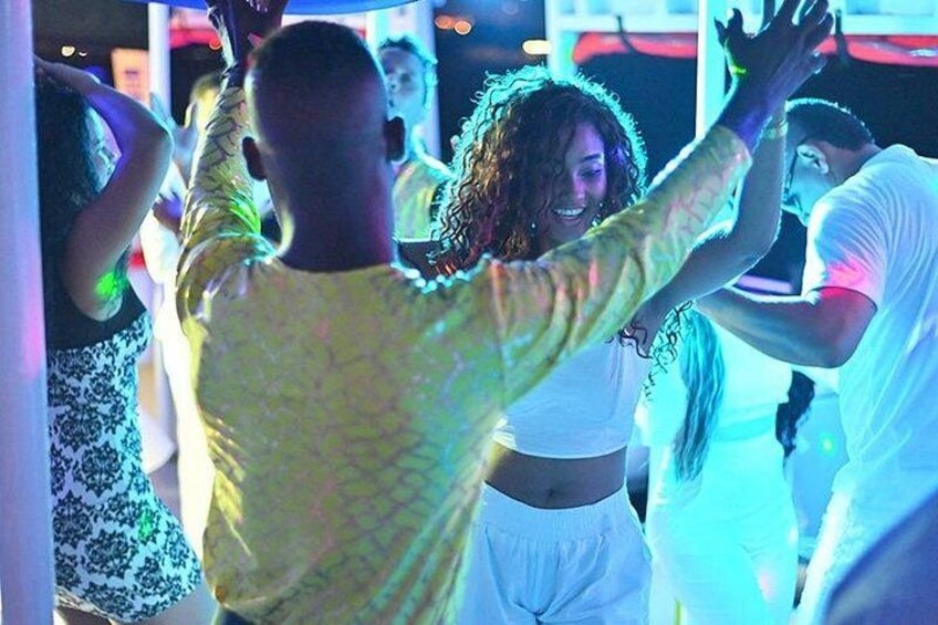 People dancing in a club with colorful lights. 3