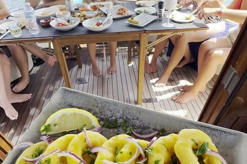 A group of people dining on a wooden deck. 5