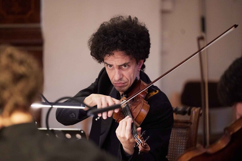 A person playing a violin. 4