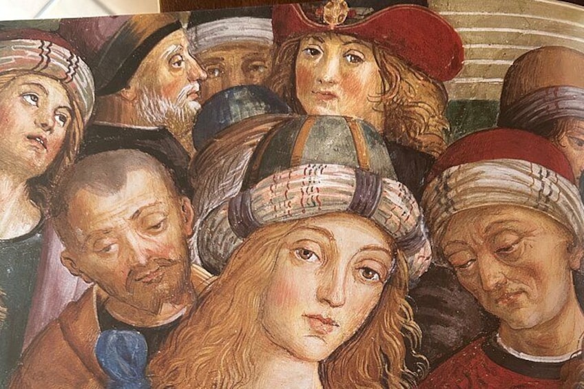 A group of people in historical attire, some with headwear, in a close-up view. 2
