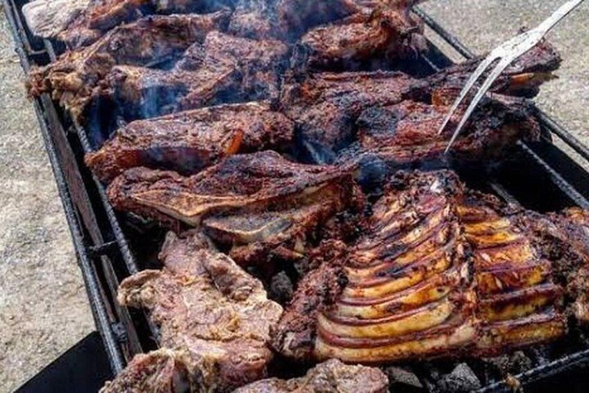 A grill with various meats being cooked. 4