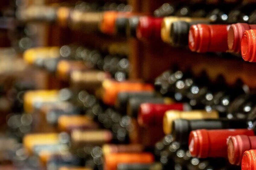 A close-up of wine bottles with red and gold labels. 4