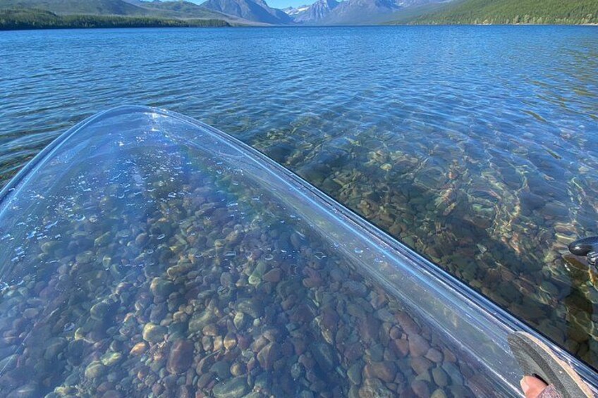 A clear lake with visible rocks and a boat. 2