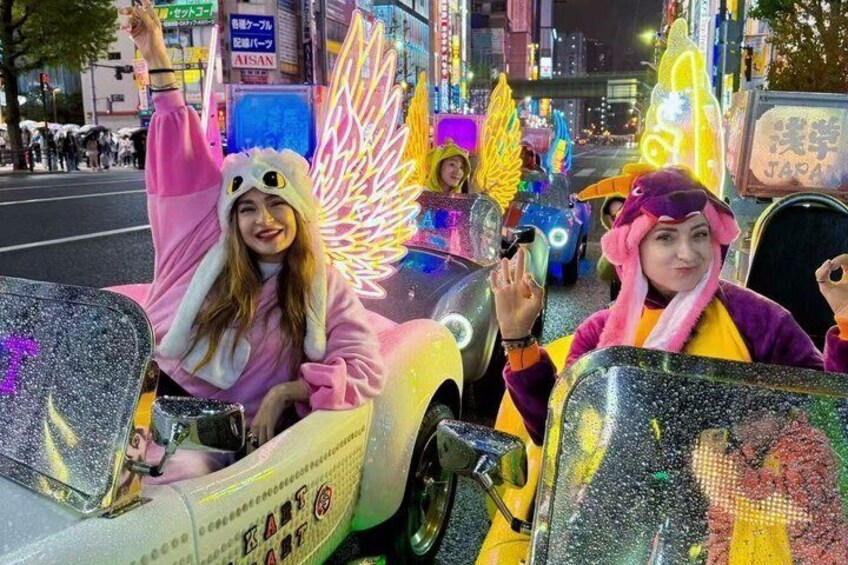 A parade float with a person in a pink costume and another in a purple costume with wings. 2