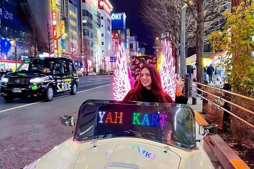 A vehicle with a sign reading 'YAH KART' and a person sitting in the front. 3