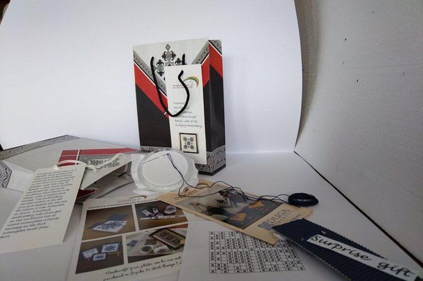 A box with a rainbow design, a white object, and scattered papers with text and images. 1