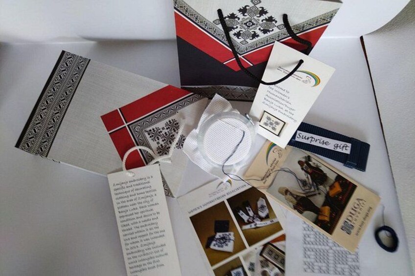 A gift box with a tag, a pair of glasses, and some papers. 3