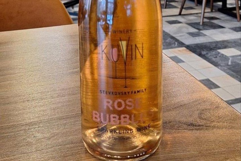 A bottle of rosé wine with a label that reads 'KOVIN STEVKOVSKY FAMILY ROSE BURBL.' 4