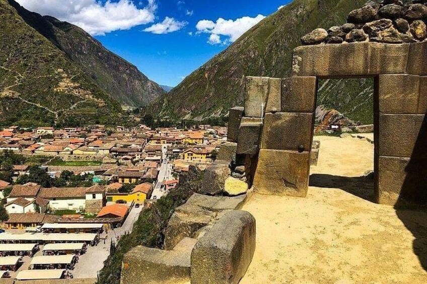 A town nestled in a valley with stone structures and a mountain backdrop. 4