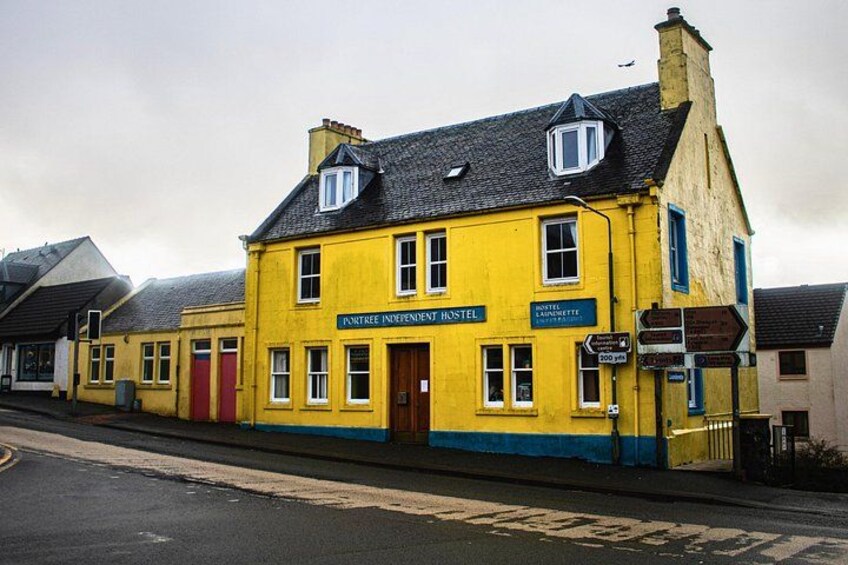 A yellow building with a sign reading 'Fortree Independent Hostel.' 3