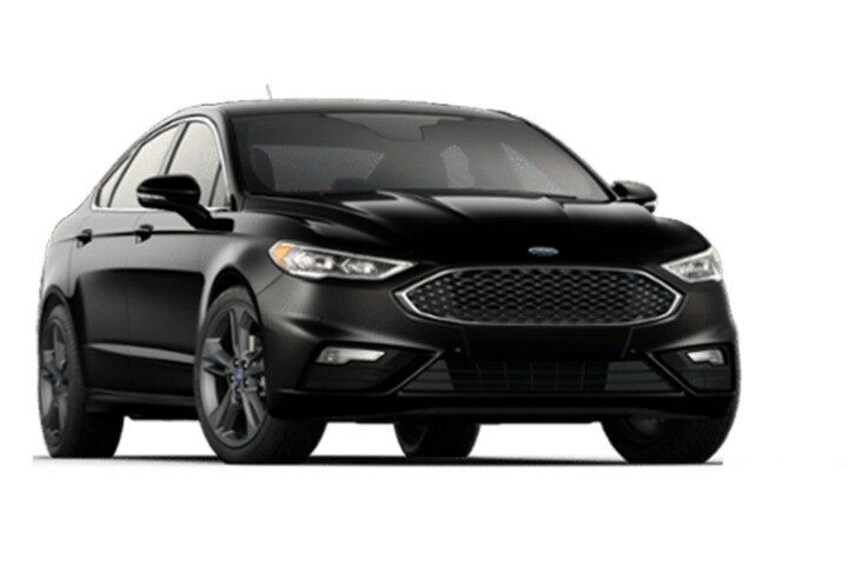 A black sedan with a prominent grille, sleek headlights, and alloy wheels. 5