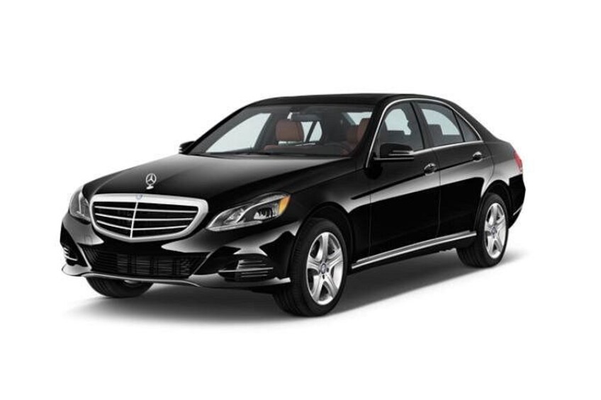 A black luxury sedan with a prominent grille, chrome detailing, and alloy wheels. 2