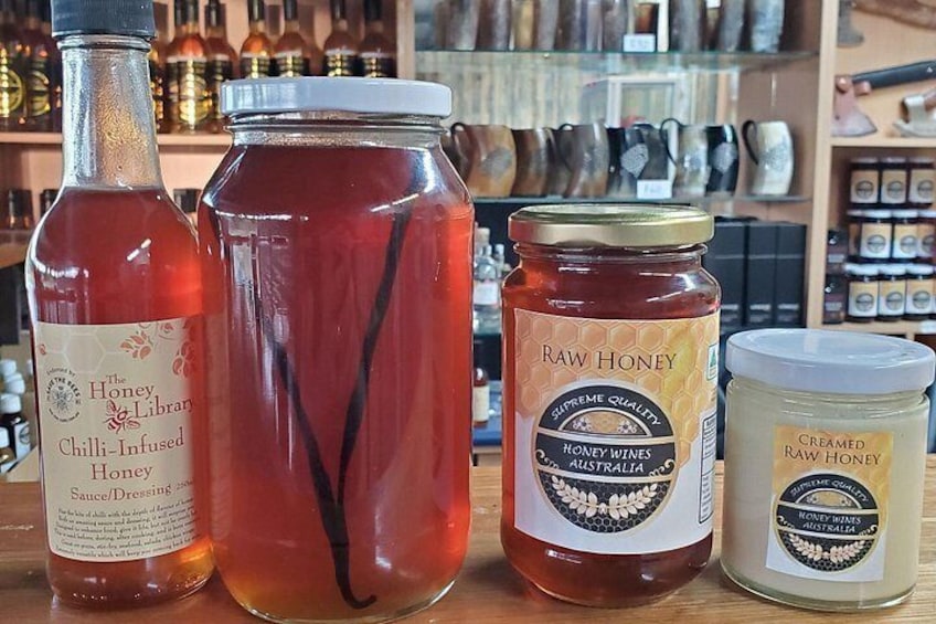 A selection of honey products including a bottle, a jar, and a container. 5