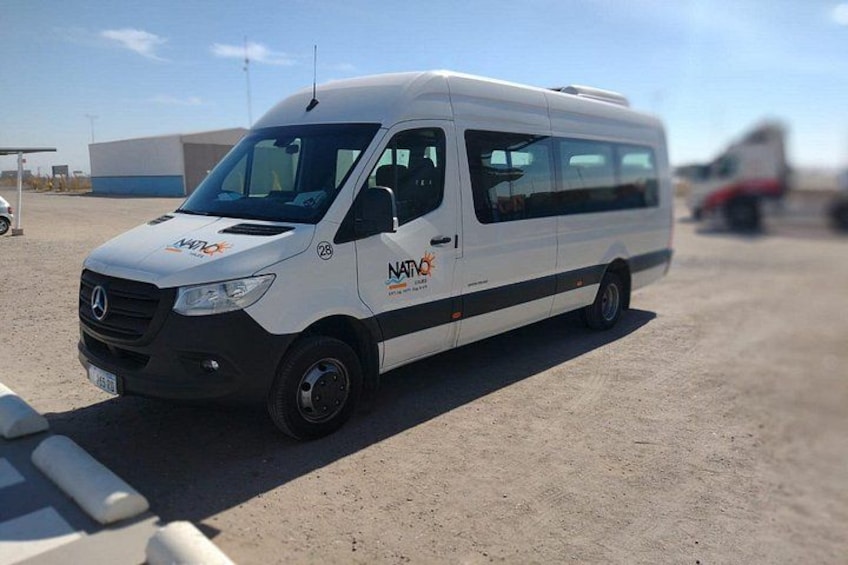 A white van with 'NATIV' branding parked on a dirt surface. 3
