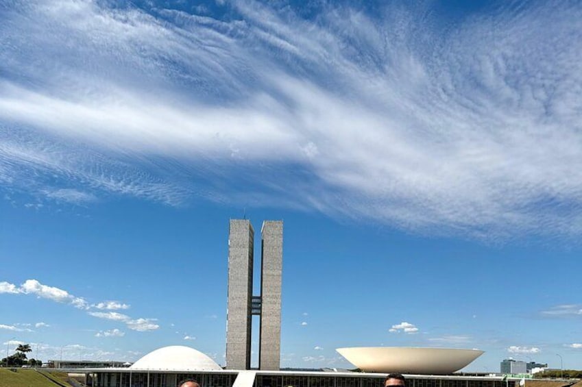 A modern architectural structure with two tall, narrow towers and a large white dome. 5
