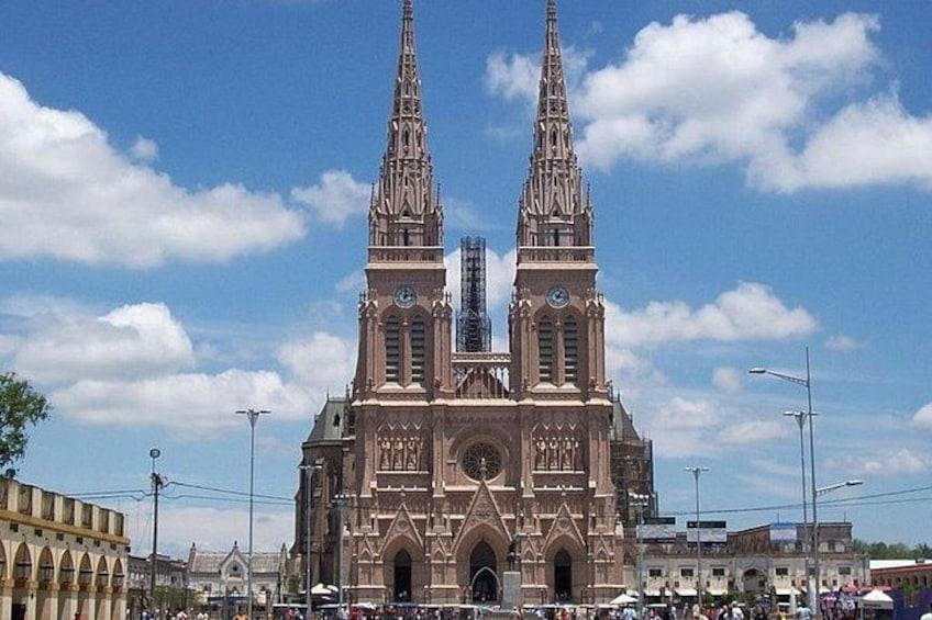 A large cathedral with two tall spires and a central clock tower. 1