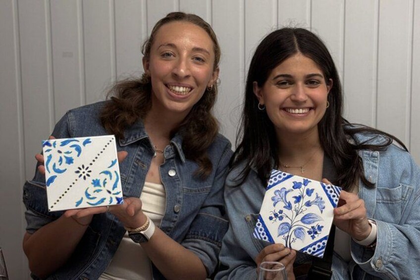 Two individuals holding patterned boxes. 3