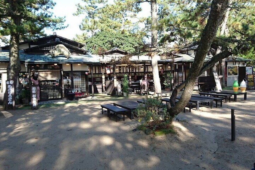 A traditional Japanese outdoor seating area with wooden structures and benches. 4