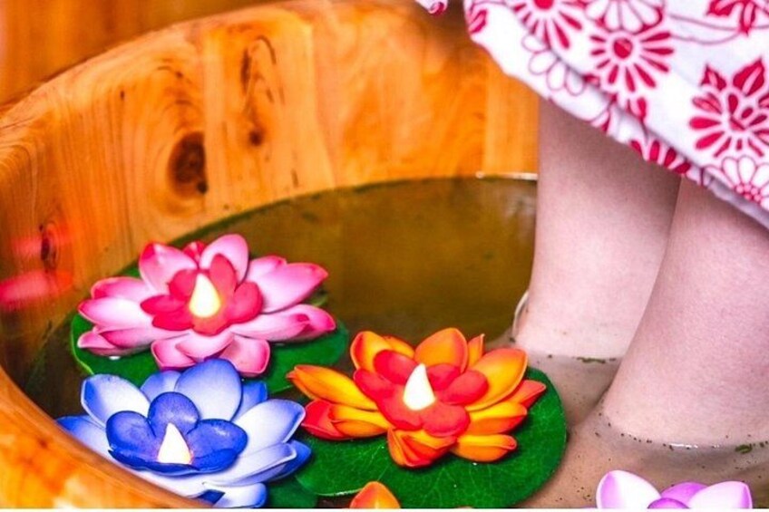 A wooden basin with lotus flowers and candles. 4