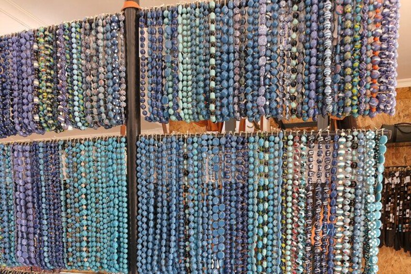 A wall covered with rows of colorful beads. 5