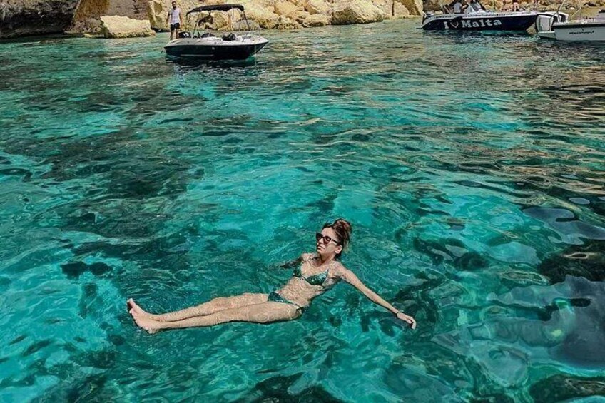 Float peacefully in the crystal-clear waters of Crystal Lagoon, surrounded by breathtaking cliffs and hidden caves on a private boat tour in Malta. 2