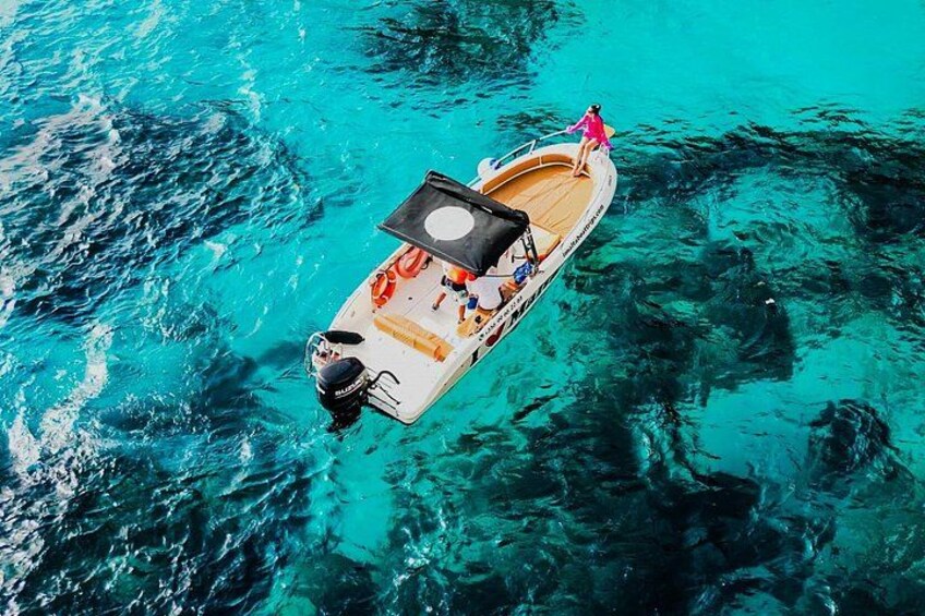 Sit and relax on the dolphin platform at the prow of the boat, enjoying breathtaking views of Comino and Crystal Lagoon on a private boat tour 2