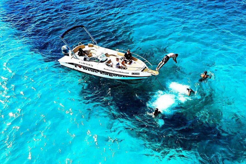 Jump off the prow with your friends into the crystal-clear waters of Blue Lagoon, making unforgettable memories on a private boat tour in Malta 3