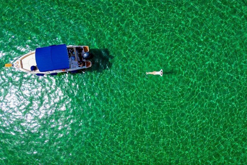 Captured from above! A breathtaking drone shot of you floating in the crystal-clear waters of Blue Lagoon, surrounded by stunning scenery on a private boat tour in Malta 4