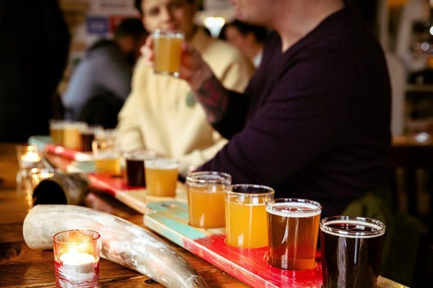 A bar with glasses of beer and a candle. 4