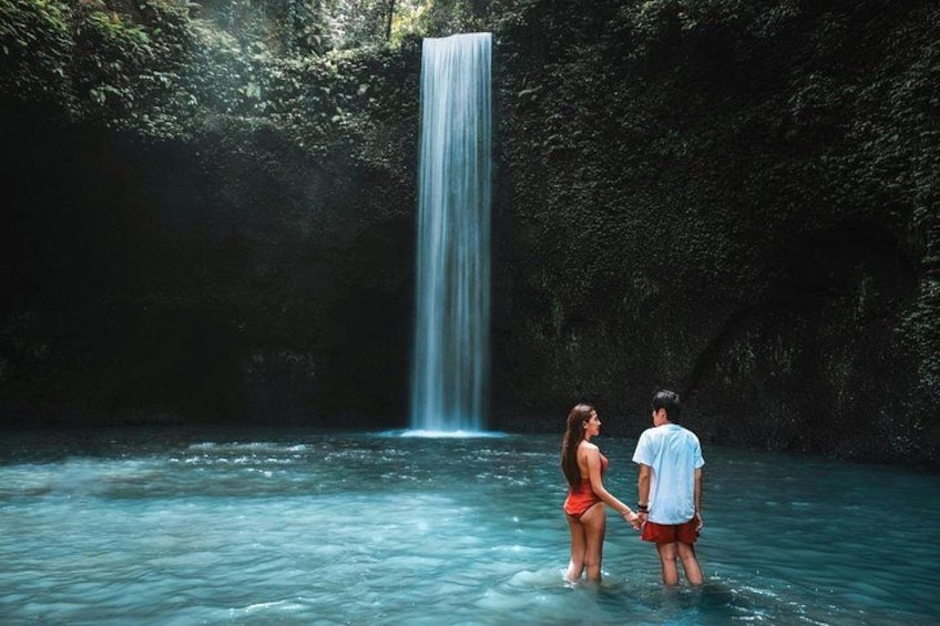 A waterfall, a couple, and a forested area. 4