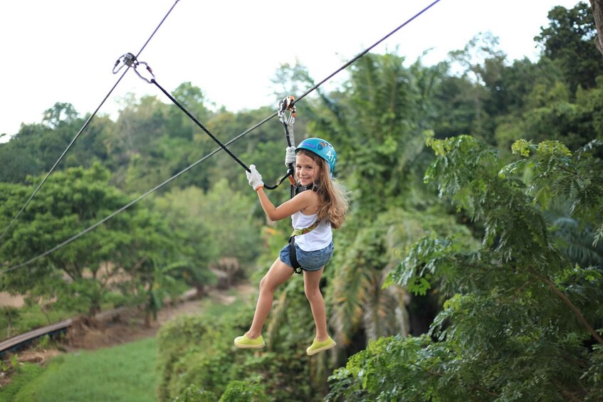 A person zip-lining through a forested area. 2