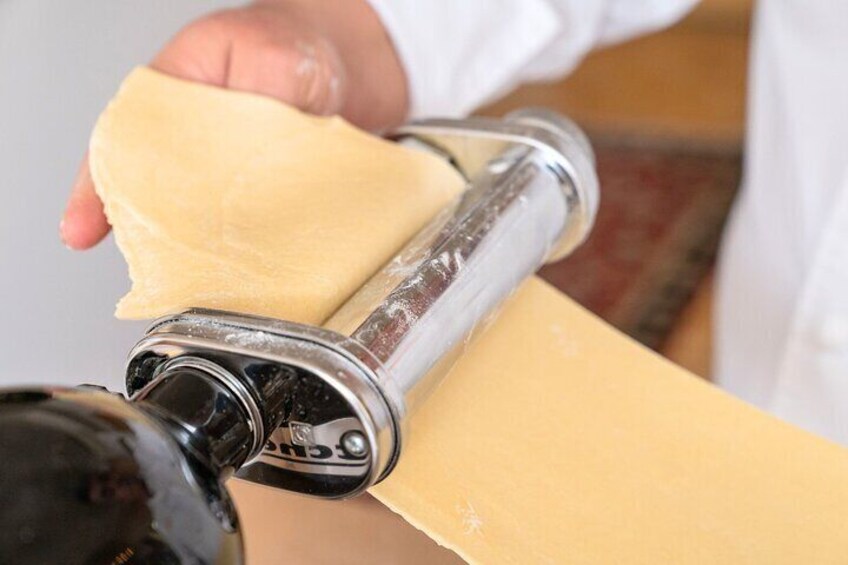 A person rolling out dough with a rolling pin. 3