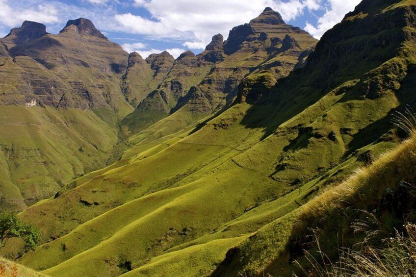 A mountainous landscape with rolling hills and rugged peaks. 3