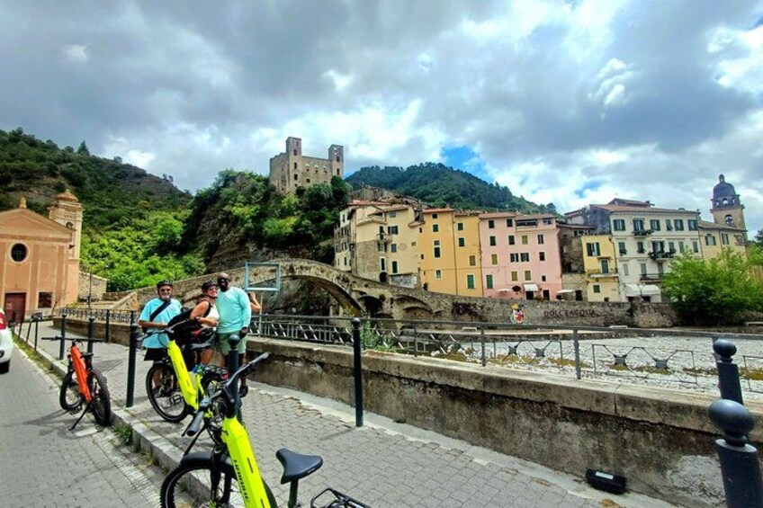 A bridge, bicycles, and historic buildings along a riverside. 3