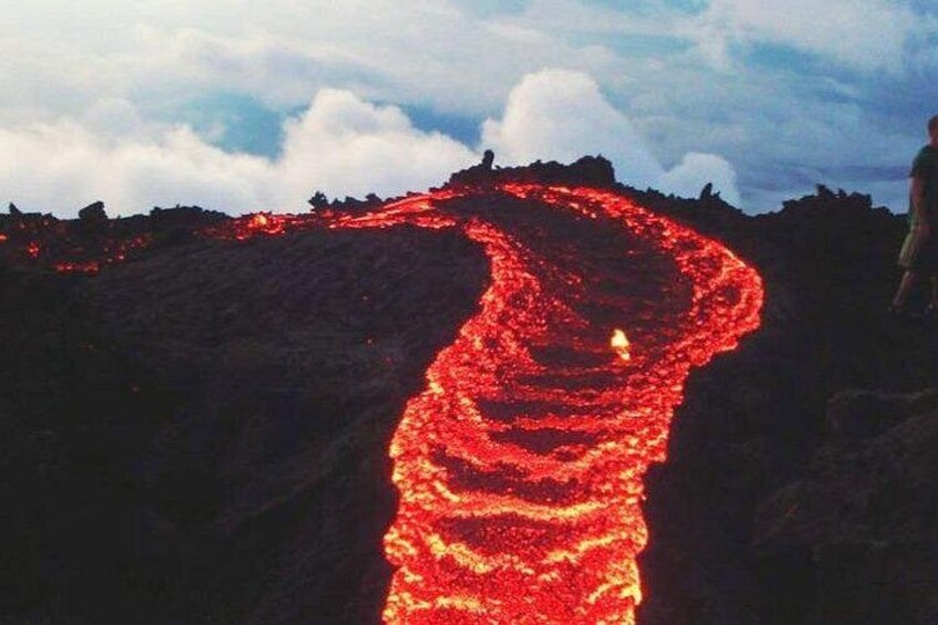 A lava flow winding down a volcanic slope. 1