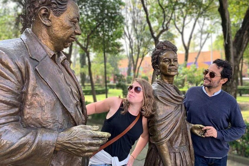 A bronze statue of a man in a suit and a bronze statue of a woman in a dress. 2