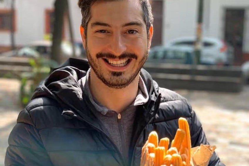 A person holding a bunch of orange carrots. 4